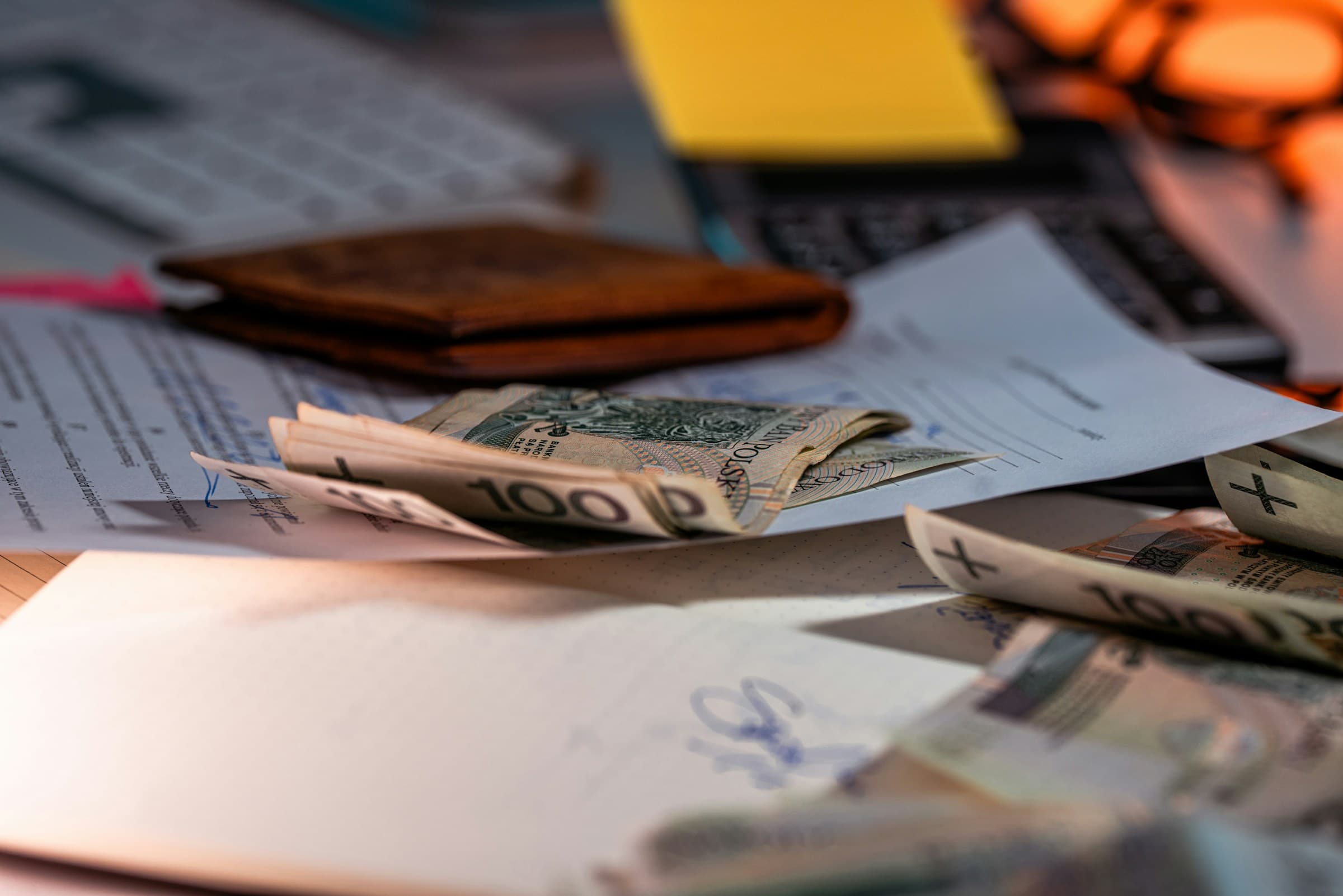 Money and financial documents arranged on a desk